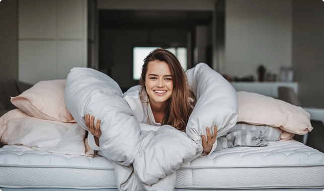 woman-is-laying-bed-with-pillows-white-blanket-that-says-smile_332042358.htm-228801-ezgif.com-png-to-webp-converter